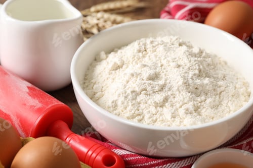 Preview: Rolling pin and ingredients for dough on table, closeup