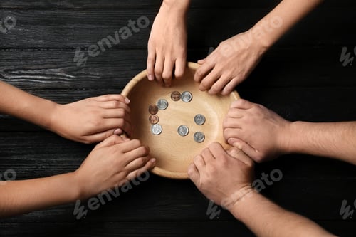 Preview: Poor people holding bowl with coins on wooden background, top view