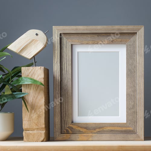 Preview: empty photo frame, wooden craft toy and artificial flower in pot on gray background