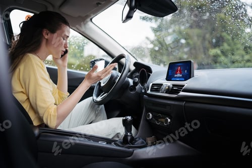 Preview: Young woman sitting in electric car with drained battery, making a phone call to service center.