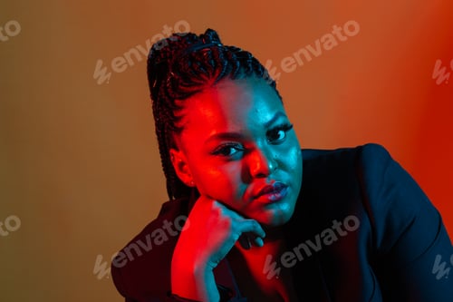 Preview: Beautiful young African woman posing against a dark background