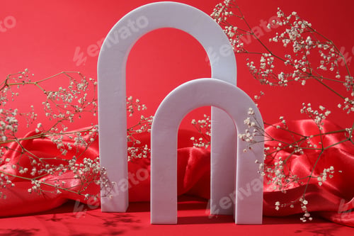 Preview: Promotion. White figures, fabric and gypsophila flowers on red background