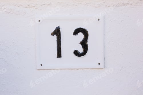 Preview: House number Thirteen on Stone Wall close-up