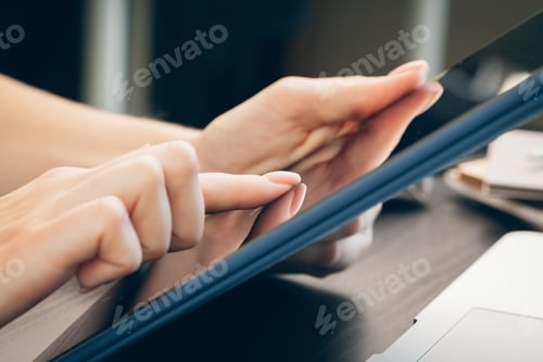 Preview: Woman using digital tablet in an office close up