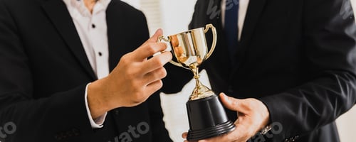 Preview: Cheerful business team winning trophy