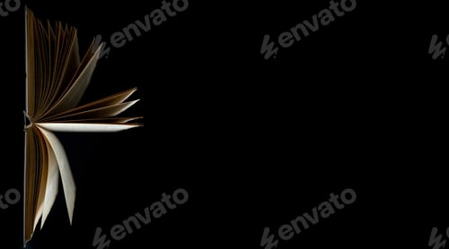 Preview: Open book with pages on a black background.