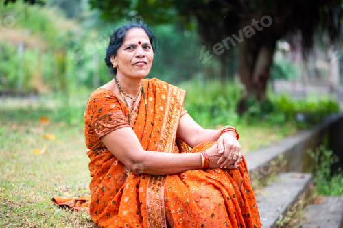 Preview: Happy Indian woman in traditional clothes at outdoor.
