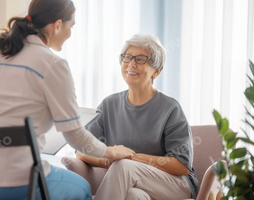 Preview: Smiling Senior Woman Talking with Caregiver in Home