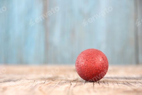 Preview: Red Christmas ball on wood table background