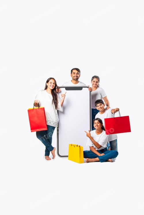 Preview: asian Indian family promoting sale offer standing with big tall smartphone cutout