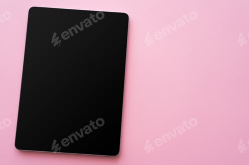 Preview: top view of digital tablet with blank screen on pink