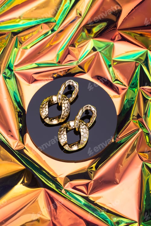 Preview: Golden chains earrings on black background.