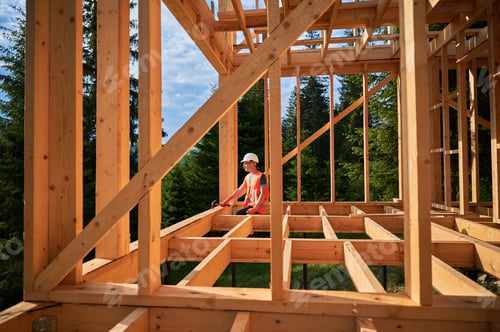 Preview: Carpenter constructing wooden frame house.