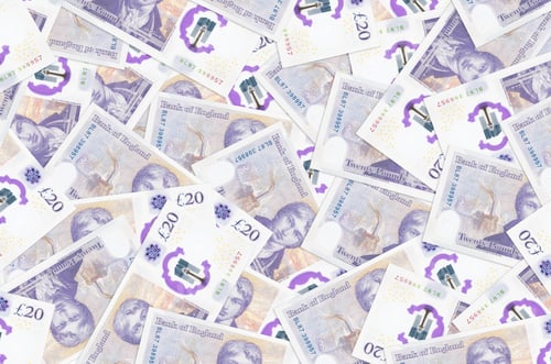 Preview: 20 British pounds bills lies in big pile. Rich life conceptual background