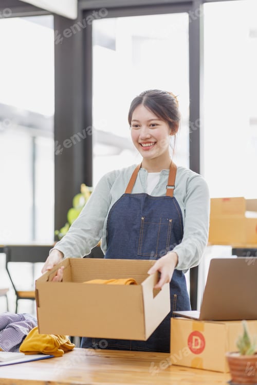 Preview: Startup small business SME. young Asian entrepreneurs using laptop computer check online orders and