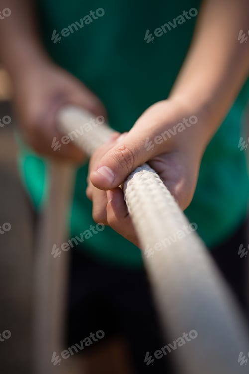 Preview: Boy practicing tug of war during obstacle course training in the boot camp