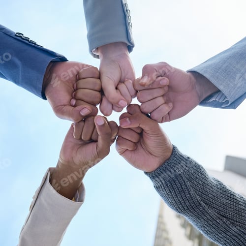 Preview: Below shot of a group of unrecognizable businesspeople joining their hands together in a unity
