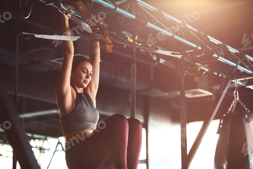 Preview: Abs workout. Vertical shot of a young attractive fitness woman wearing sportswear exercising on