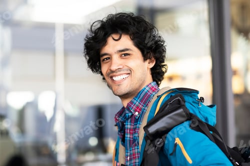 Preview: Young man outside with bag
