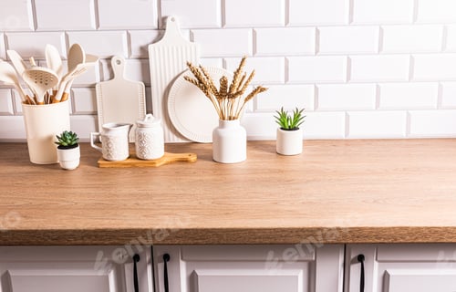 Preview: White ceramic utensils and kitchen utensils on a wooden countertop in an eco-friendly kitchen.
