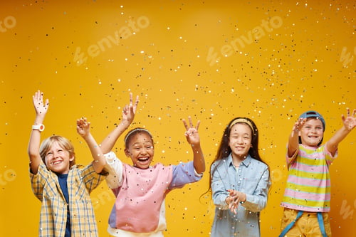 Preview: Diverse Group of Four Preteen Kids Catching Confetti in Orange Studio