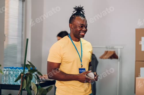 Preview: Portrait of an african american man working in community charity donation center