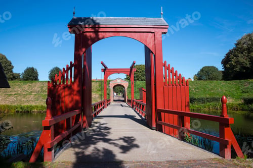 Preview: the typican red color of the bridges in bourtange in the netherlands, a old fortress touristic town