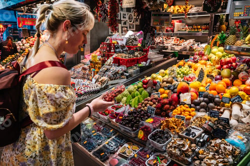 Preview: Asian woman choosing fruits in market