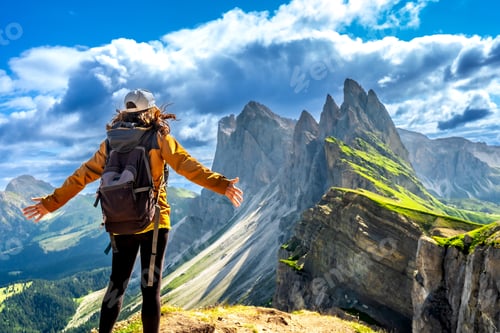 Preview: Female hiker embracing the majestic seceda peaks in the italian dolomites