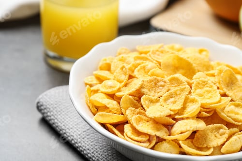 Preview: Tasty corn flakes on grey table, closeup