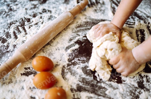 Preview: Children hands kneading dough on wooden table. Easter baking preparation. Cookies for Christmas.
