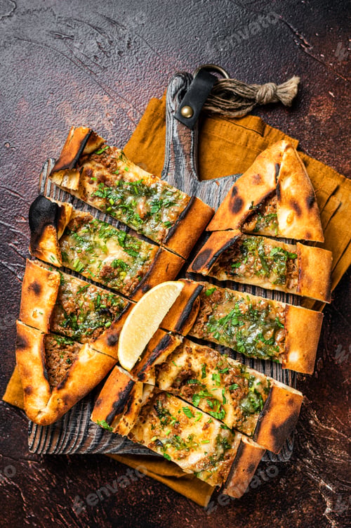 Preview: Traditional Turkish baked pide, Middle Eastern snack. Turkish pizza. Dark background. Top view