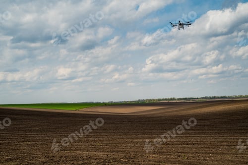 Preview: Drone Flying Over Cultivated Fields on Cloudy Day