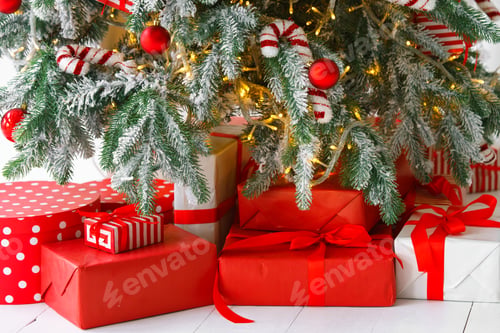 Preview: Red Wrapped Gift Boxes, Presents Under Festive Christmas Tree With Lights And Holiday Decorations