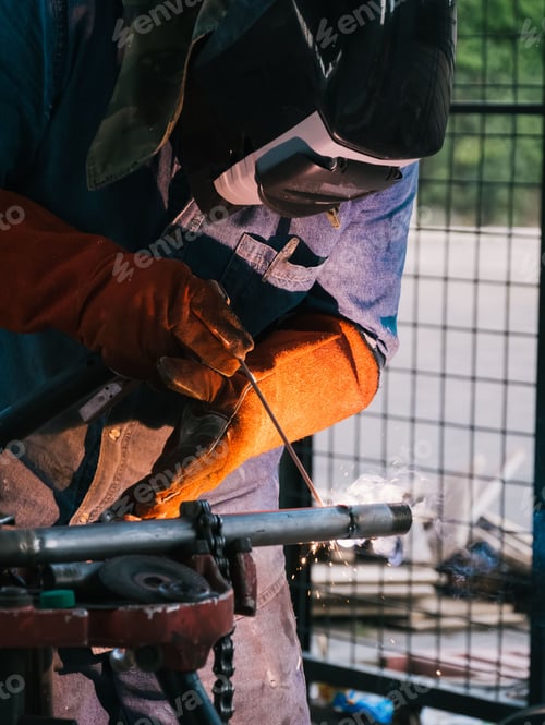 Preview: Man working on iron soldering in a workshop