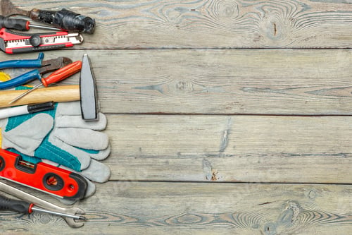 Preview: Various tools and gloves placed on wooden surface for repair work