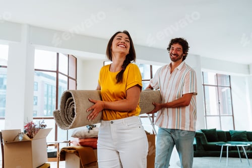 Preview: Happy young couple relocating in a new apartment.
