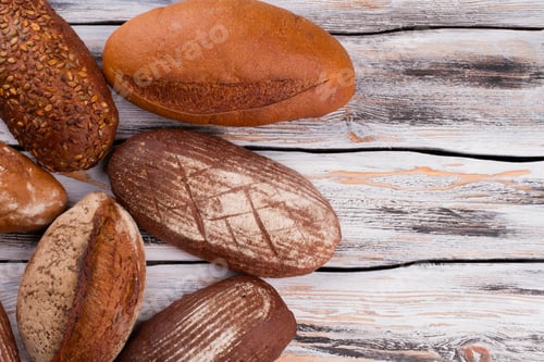 Preview: Artisan bread loaves on wooden background.
