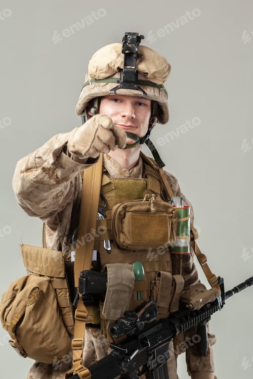 Preview: Soldier poses with weapon in military gear indoors during training session