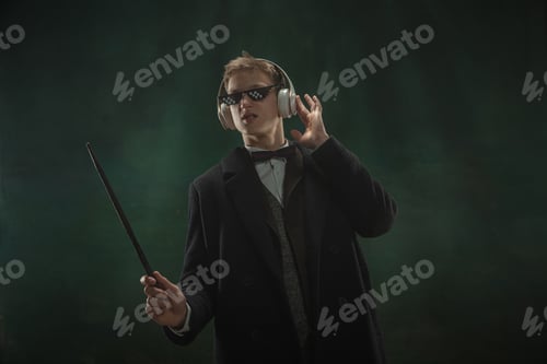 Preview: Young man in art action isolated on dark green background. Retro style, comparison of eras concept