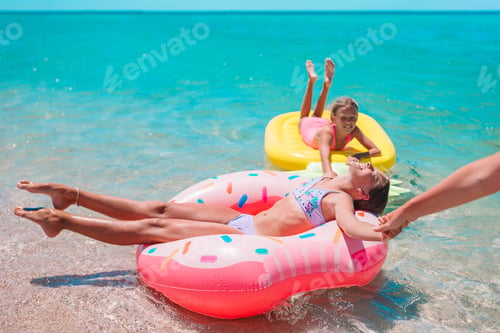Preview: Little girls having fun at tropical beach during summer vacation playing together