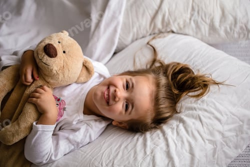 Preview: little girl in bed with soft toy the emotions of a child