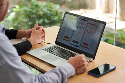 Person Working on Pricing Plans at a Desk