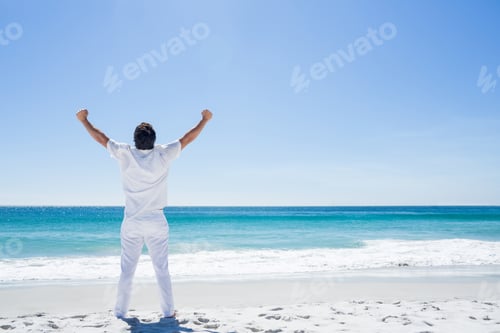 Preview: Man Stretching His Arms In Front Of The Sea At The Beach