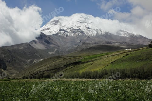 Preview: Chimborazo Volcano surrounded by green fields. The Highest mountain in Ecuador