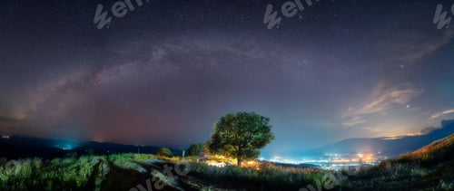 Preview: Milky way with starry over big tree on hill in the night