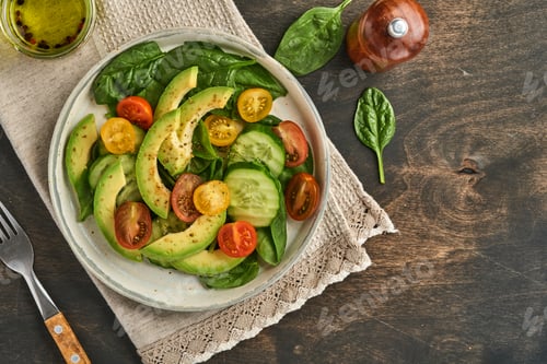 Preview: Avocado, red, yellow, black cherry tomato, spinach and cucumber fresh salad with spices pepper and o