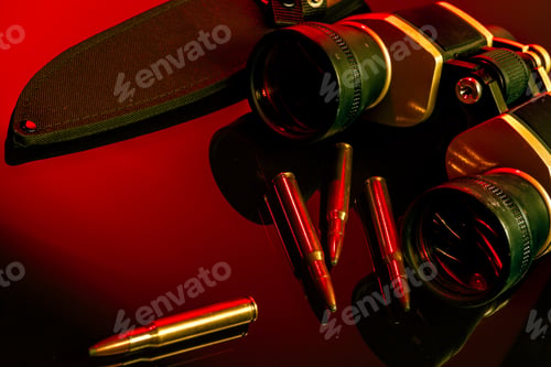 Preview: Military binoculars and cartridges on mirror background