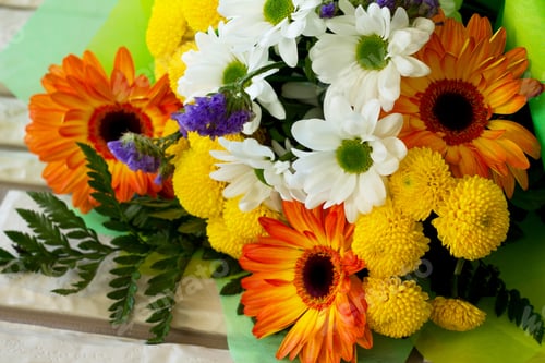 Preview: Basket bouquet of gerbera and chrysanthemums on a stone background.