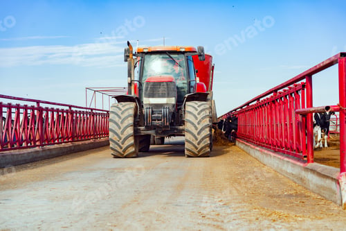 Preview: Modern red agricultural tractor in a farm
